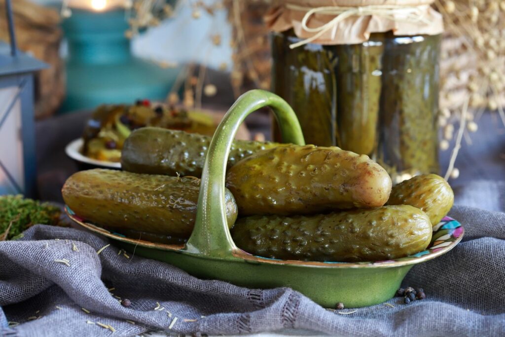 Prahos marinato receptas – stiklainiuose ir lėkštėje sudėti traškūs marinuoti agurkai, paruošti pagal ypatingą receptą.