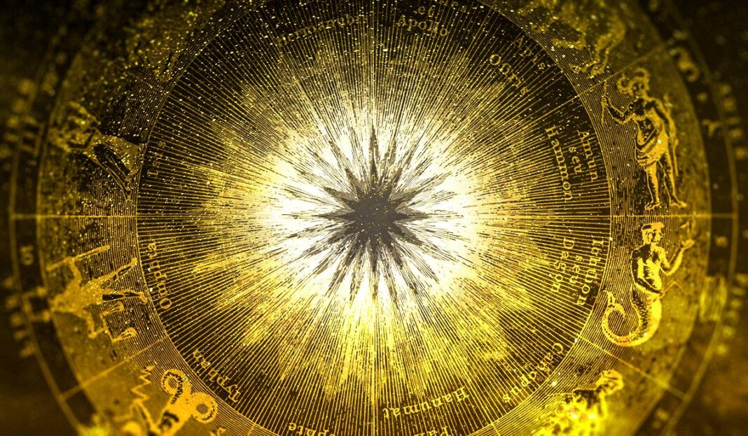 Auksinė astrologinė diagrama su zodiako ženklais ir ryškiu švytinčiu centru