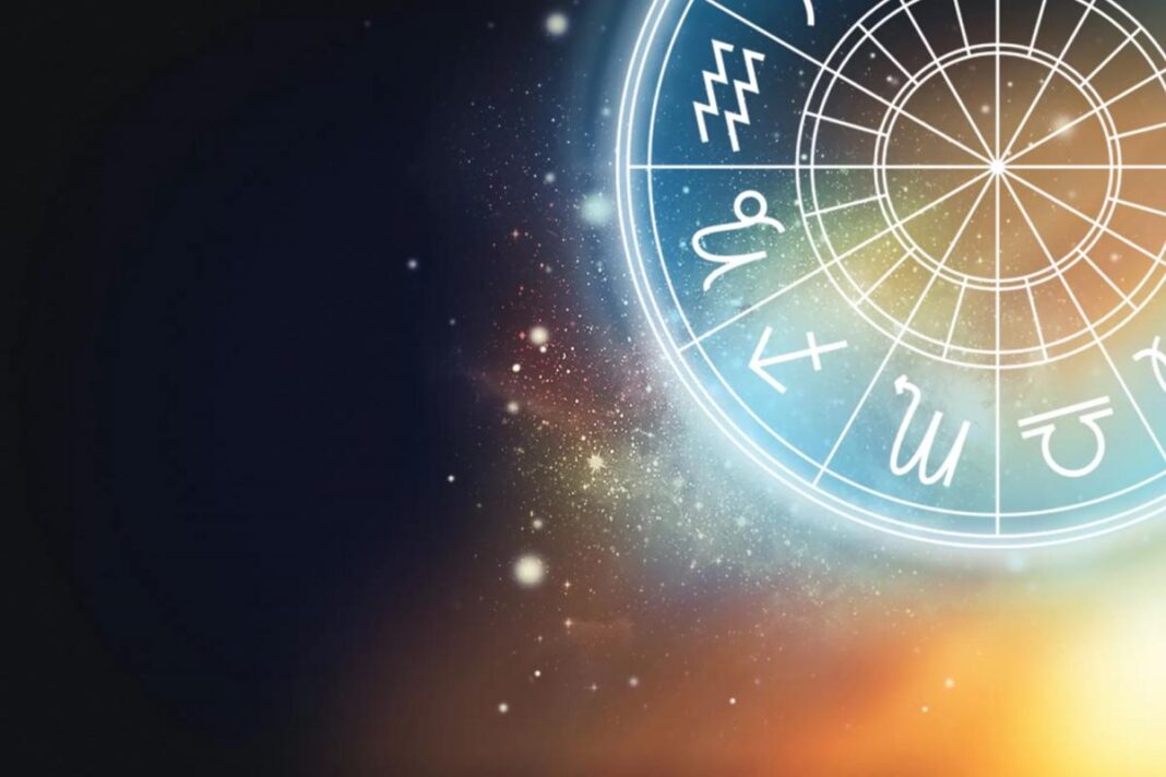 Švytintis zodiako ratas žvaigždėtame tamsiame fone